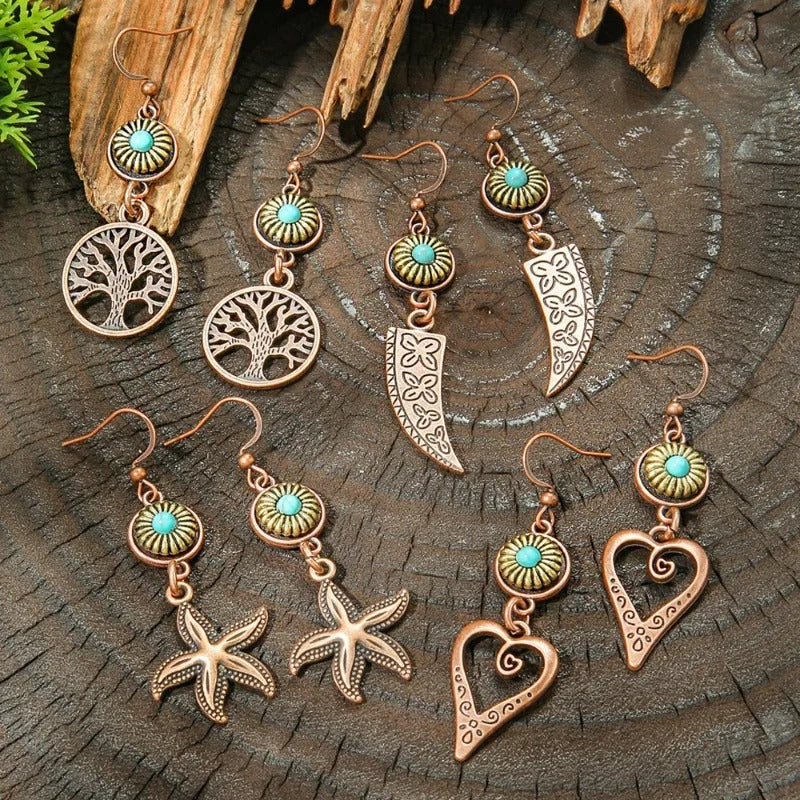 Set of copper and turquoise earrings on a wooden surface
